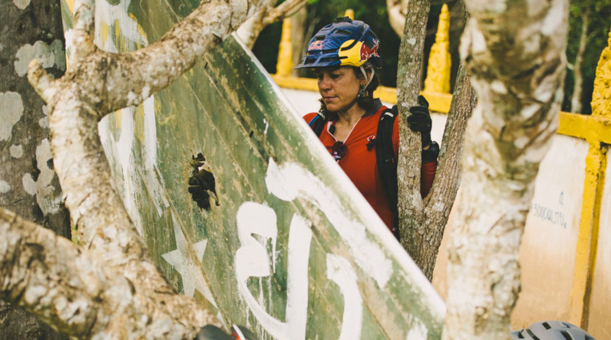 Rebecca looking at the wing of an F4 plane in the grounds of a temple in Laos.